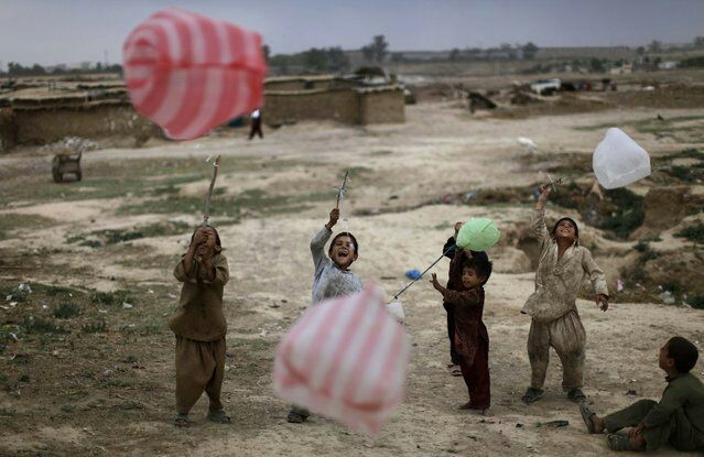 Children play with plastic bags in …