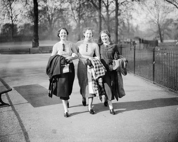 Three young women walk in St …