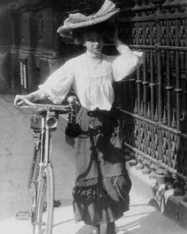 An Edwardian woman with her bicycle. …
