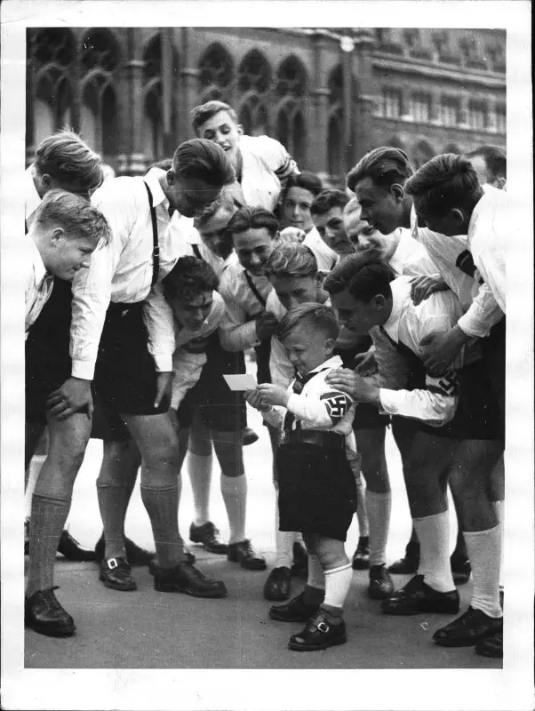 **Hitler Youth surrounding a young "Pimpf" …