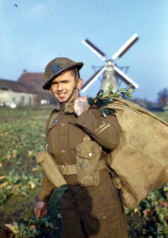 A British soldier carrying a bag …