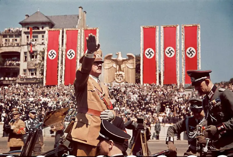 Adolf Hitler gives the German salute …
