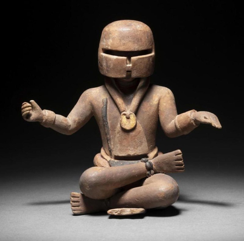 A Mayan seated MANDALORIAN figure with …