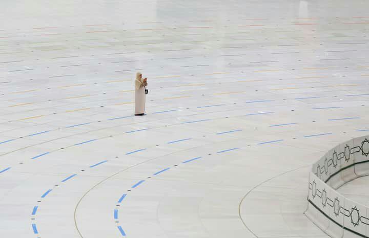 A woman stands praying to Allah …