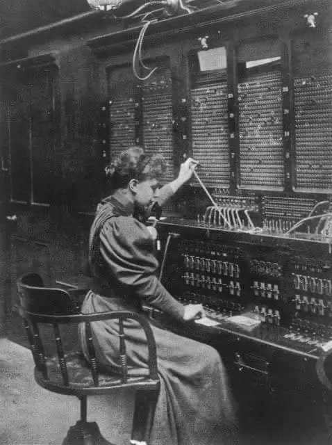 A telephone switchboard operator, c. 1900