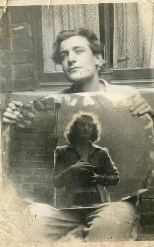 Ted Hughes holding a mirror with …