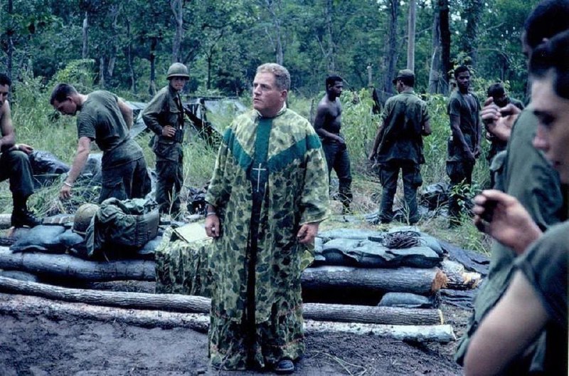 a priest wearing a camouflage cassock …