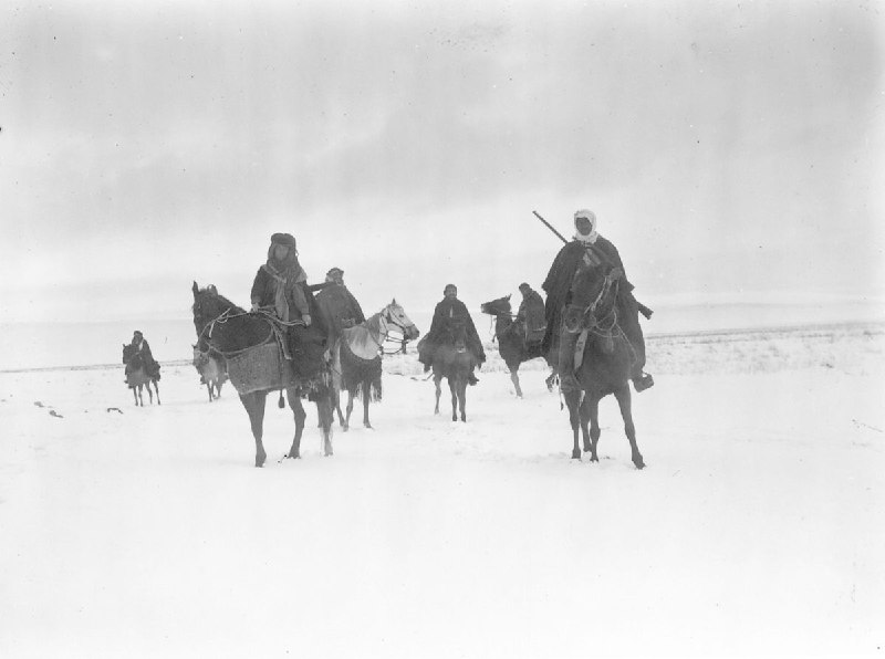 Group of horsemen in the snow …